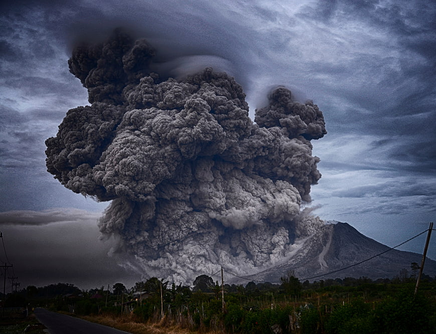 Massive Volcanic Eruption Plume Over Rural Landscape