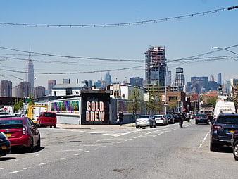 New York City street scene with skyline and parked cars