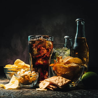 Dark Moody Still Life of Soda, Chips, and Snacks