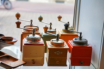 Collection of vintage manual coffee grinders on display
