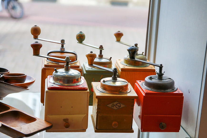 Collection of vintage manual coffee grinders on display