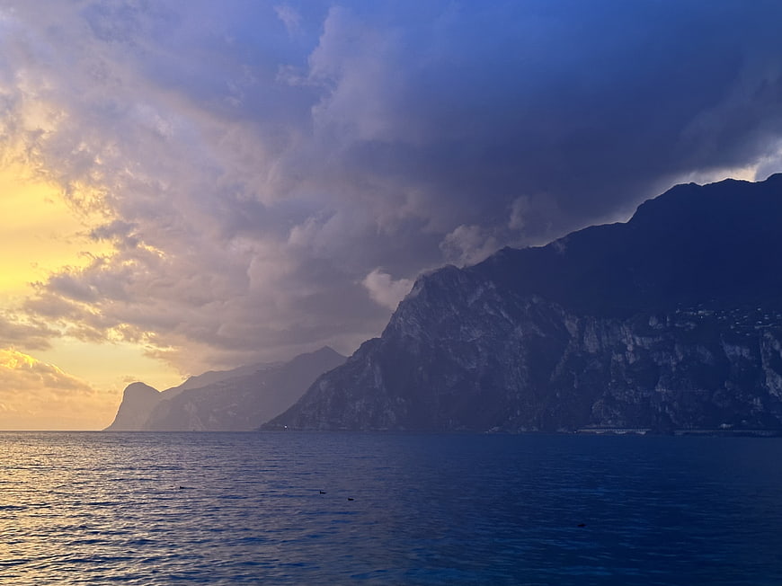 Dramatic Coastal Sunset with Mountains and Clouds