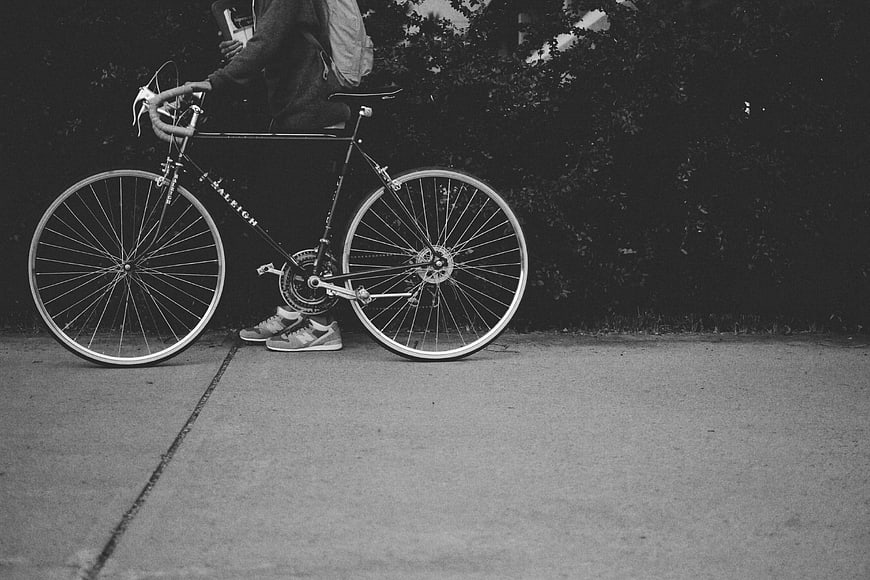 Black and white photo of cyclist with Raleigh bicycle