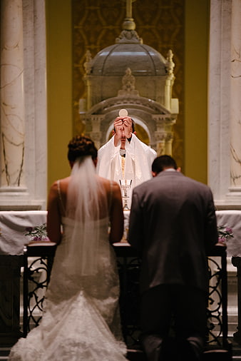 Catholic Wedding Mass with Priest Elevating Host
