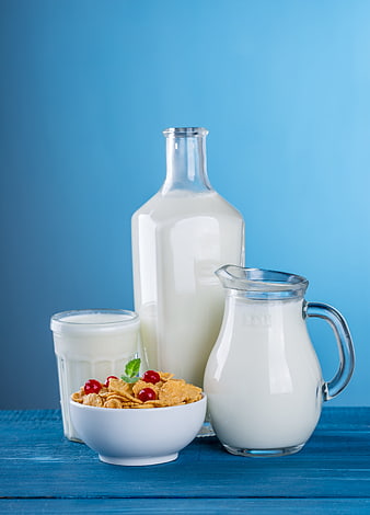 Healthy breakfast cereal with milk and cherries on blue background