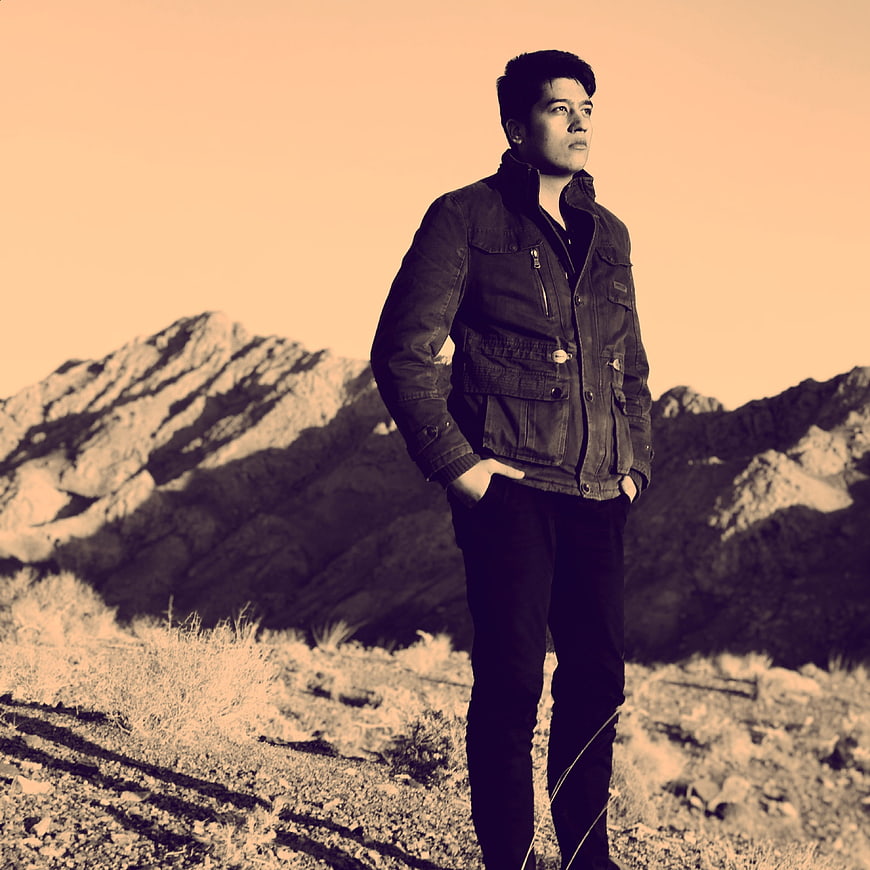 Man in Jacket Standing in Desert Landscape