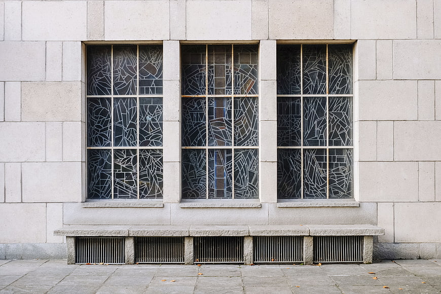 Modernist building facade with geometric stained glass windows