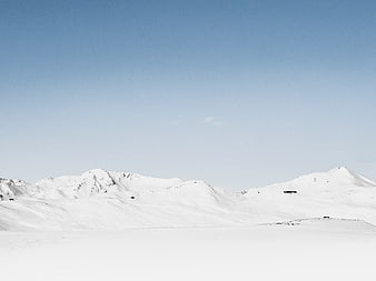 Serene Snow-Covered Mountain Landscape Under Clear Blue Sky