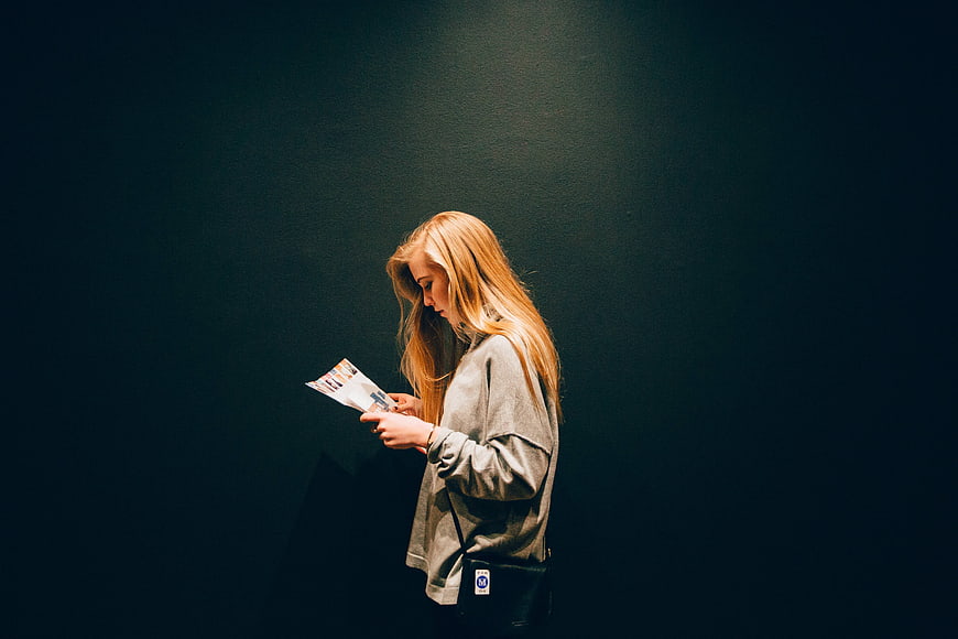 Woman Reading Magazine in Spotlight