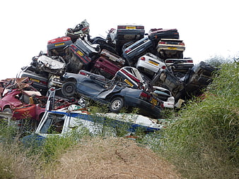 Large pile of crushed scrap cars in a junkyard