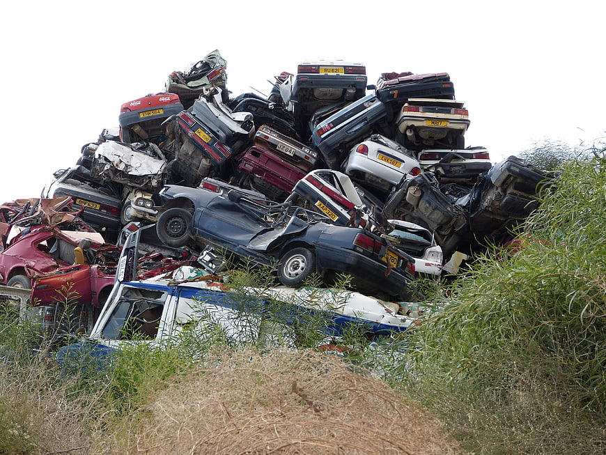 Large pile of crushed scrap cars in a junkyard