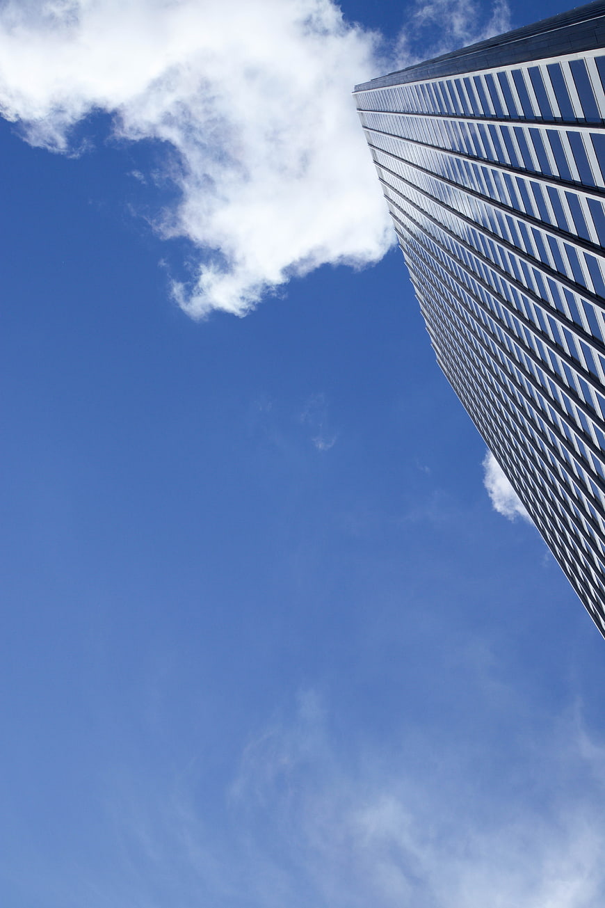 Modern Skyscraper Against Blue Sky with Clouds