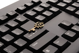 Vintage Brass Key on Black Computer Keyboard Enter Key