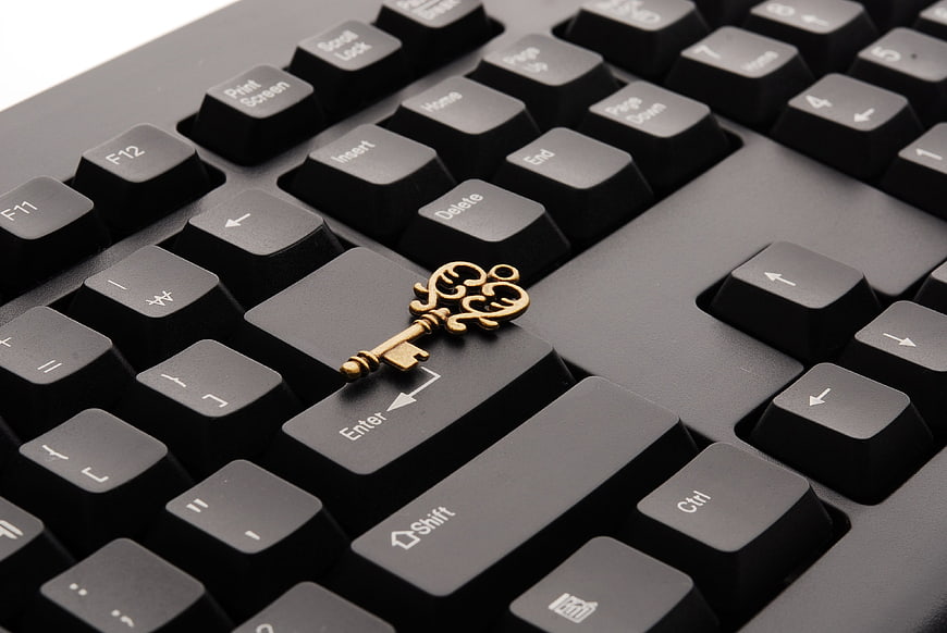 Vintage Brass Key on Black Computer Keyboard Enter Key
