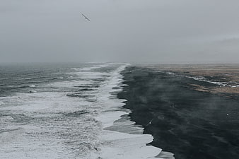 Aerial View of Stormy Ocean Waves Crashing on Black Sand Beach