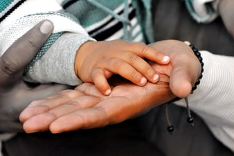 Adult Hand Holding Small Child Hand Close Up