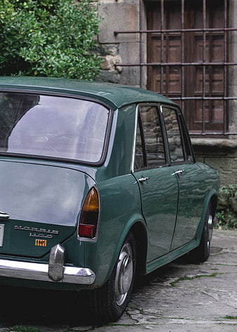 Vintage Green Morris 1100 Car Parked on Cobblestone Street