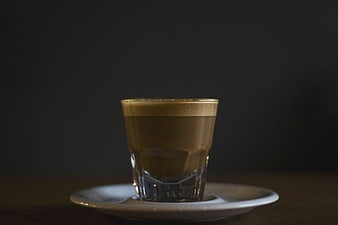 Glass of Coffee with Crema on White Saucer
