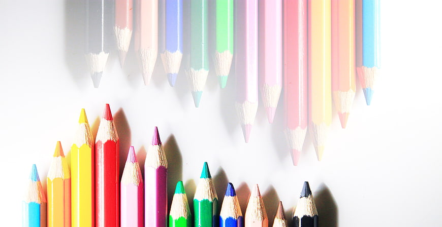 Colorful Colored Pencils Arranged In Heart Shape On White Background