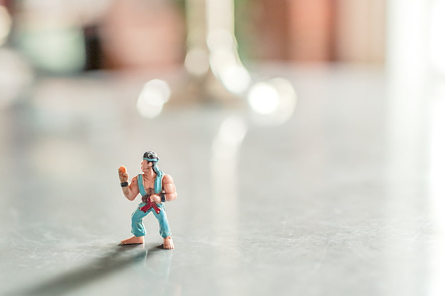 Miniature martial arts action figure on reflective surface