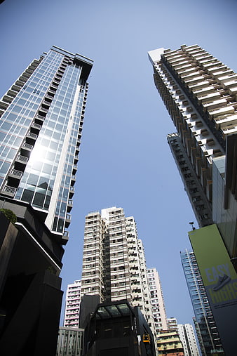 Low angle view of modern skyscrapers against blue sky