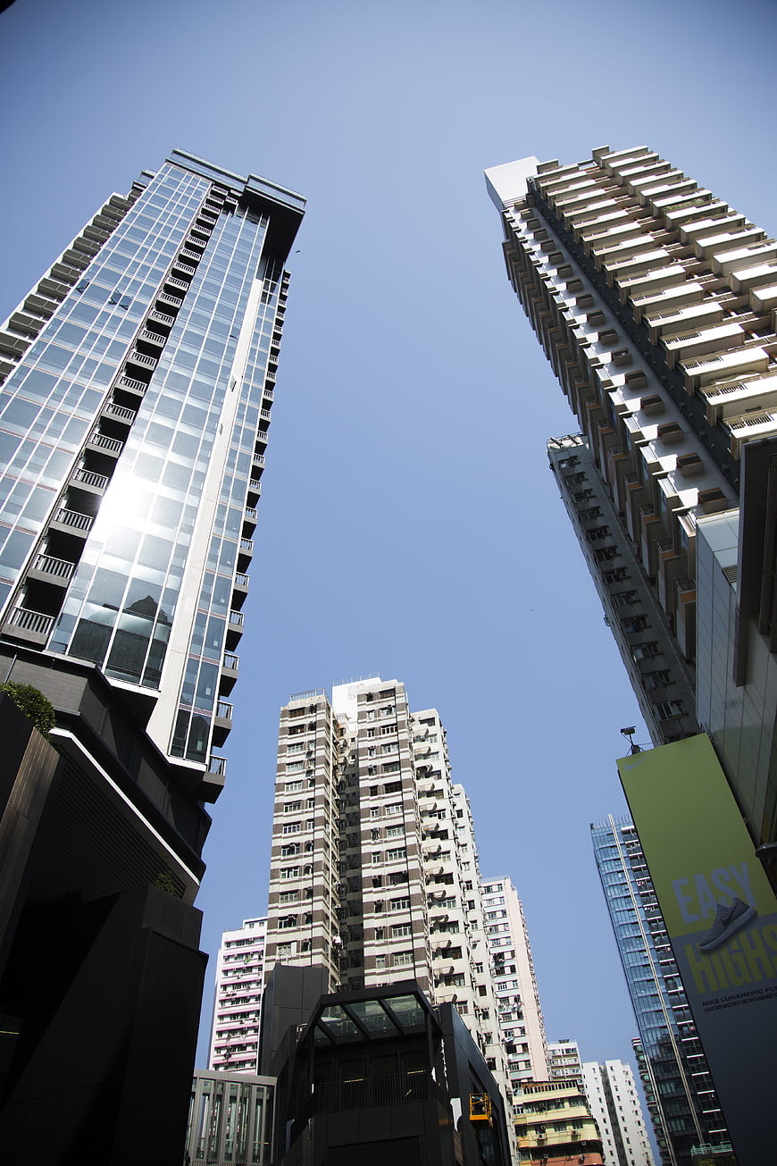 Low angle view of modern skyscrapers against blue sky