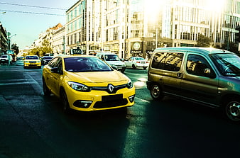 Yellow Taxi Driving on Busy City Street