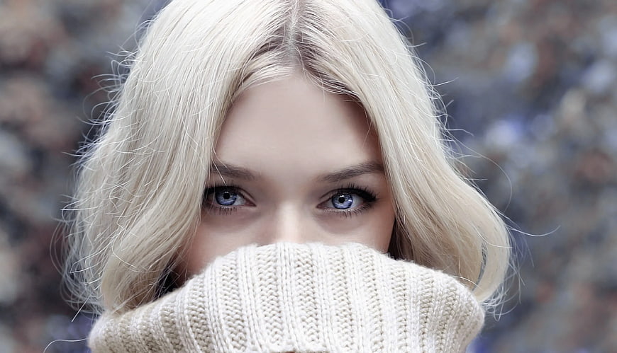Close-up of Blonde Woman with Blue Eyes in Winter Scarf