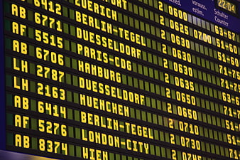 Close-up of airport departure board with yellow LED text