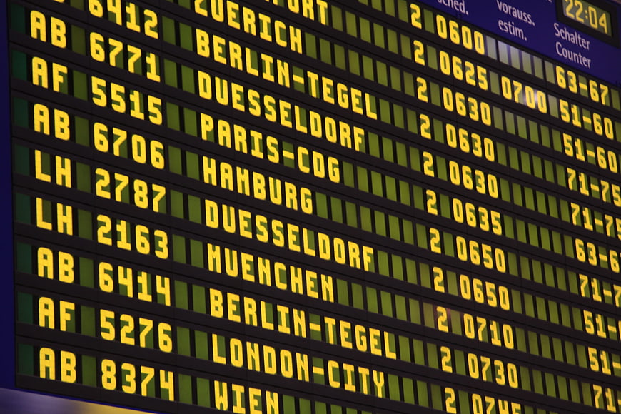 Close-up of airport departure board with yellow LED text