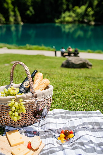 Summer Picnic Basket with Wine, Cheese, and Grapes by Lake