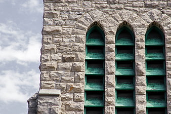 Stone Church Facade with Green Louvered Windows
