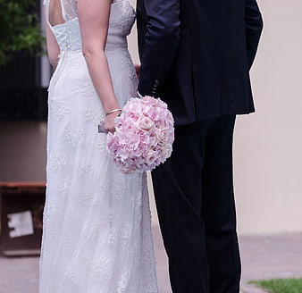 Bride and Groom Holding Pink Rose Bouquet
