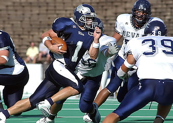 American Football Player Running with Ball in Blue Jersey
