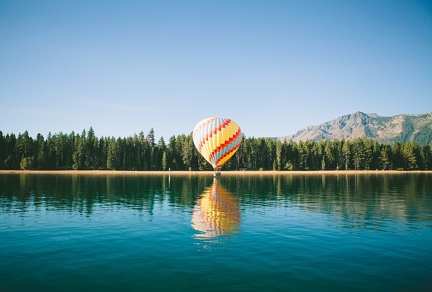 Colorful Hot Air Balloon Reflecting in Calm Lake