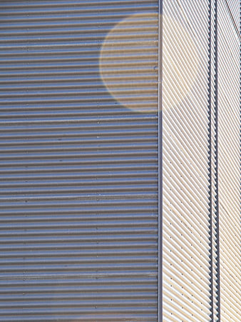 Abstract Corrugated Metal Wall with Sun Flare