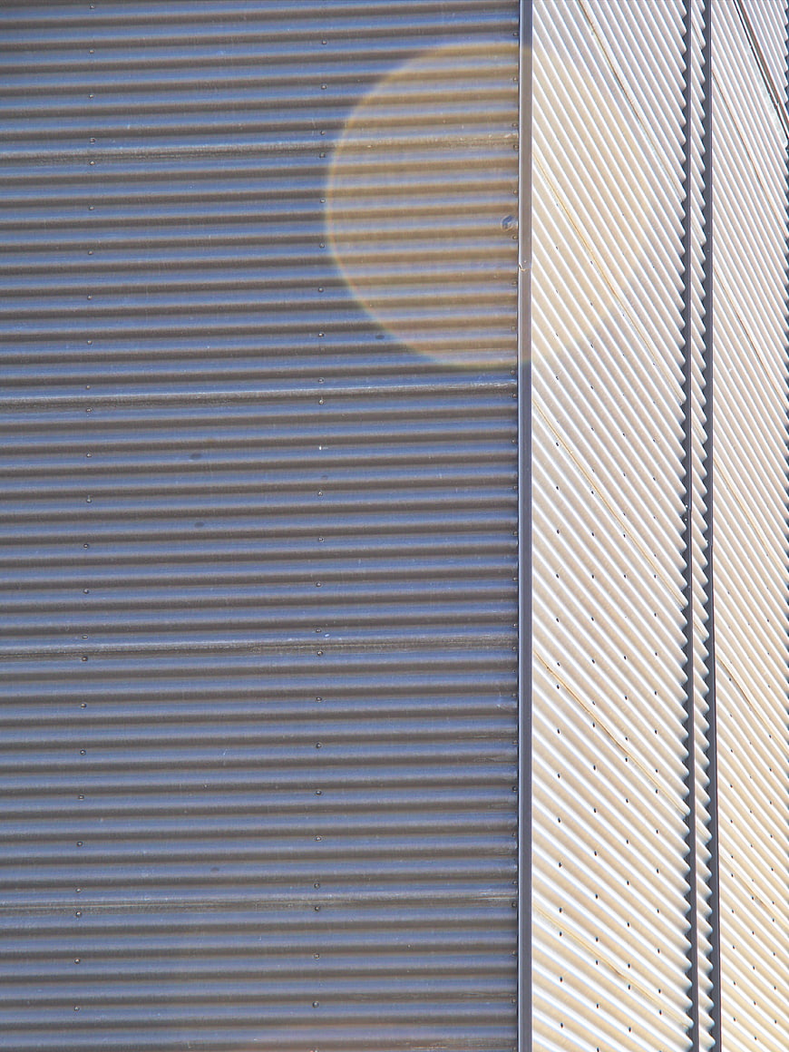 Abstract Corrugated Metal Wall with Sun Flare