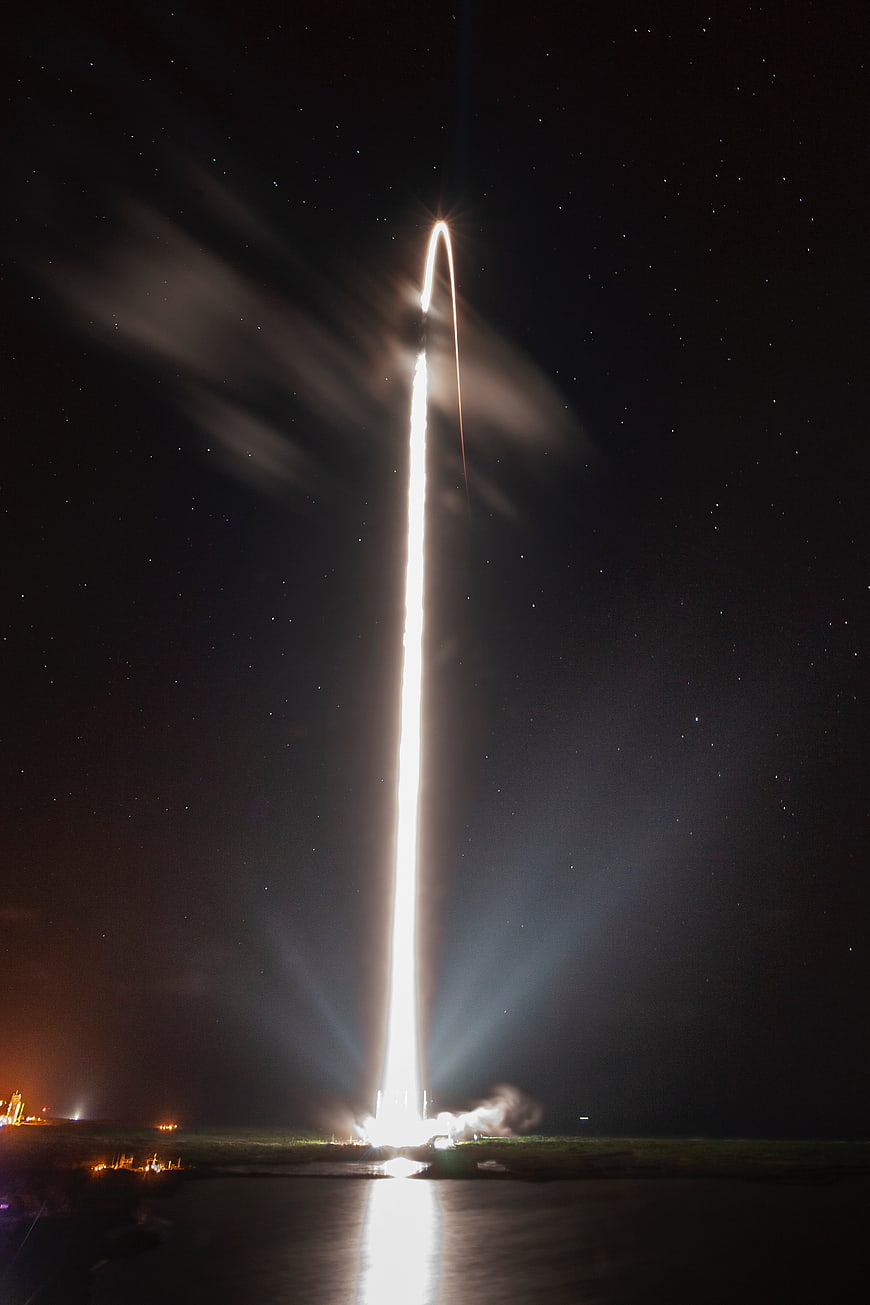Night Rocket Launch with Starry Sky and Reflection