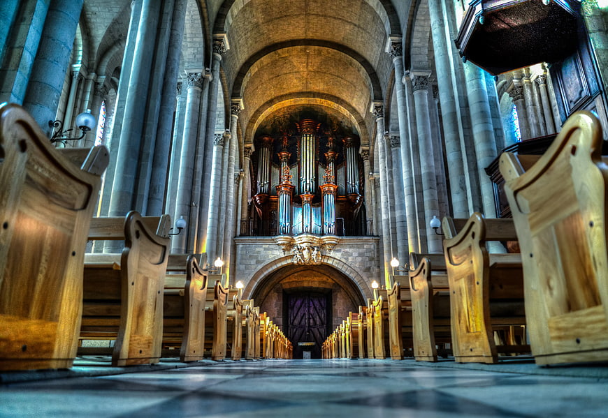 Low angle view of cathedral interior with pipe organ
