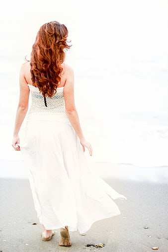 Woman in White Dress Walking on Beach