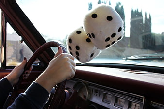 Vintage car interior with fuzzy dice hanging from rearview mirror
