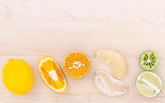 Flat lay of fresh citrus fruits on light wooden background