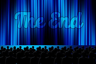 The End text on blue theater curtain with audience silhouette