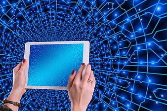 Hands holding tablet with digital network background