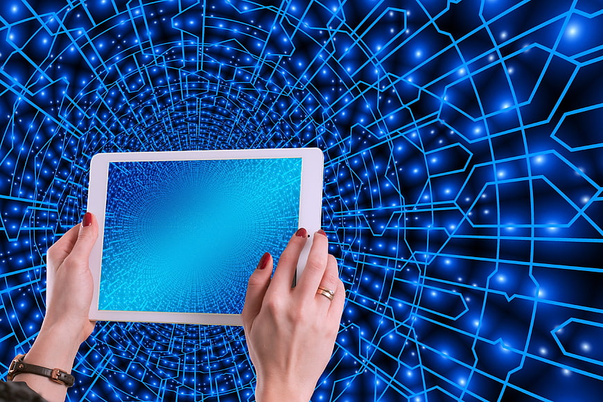 Hands holding tablet with digital network background