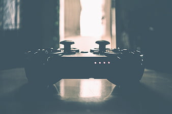 Silhouetted Gaming Controller On Table With Dramatic Backlight