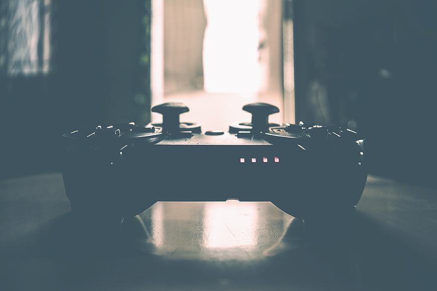 Silhouetted Gaming Controller On Table With Dramatic Backlight