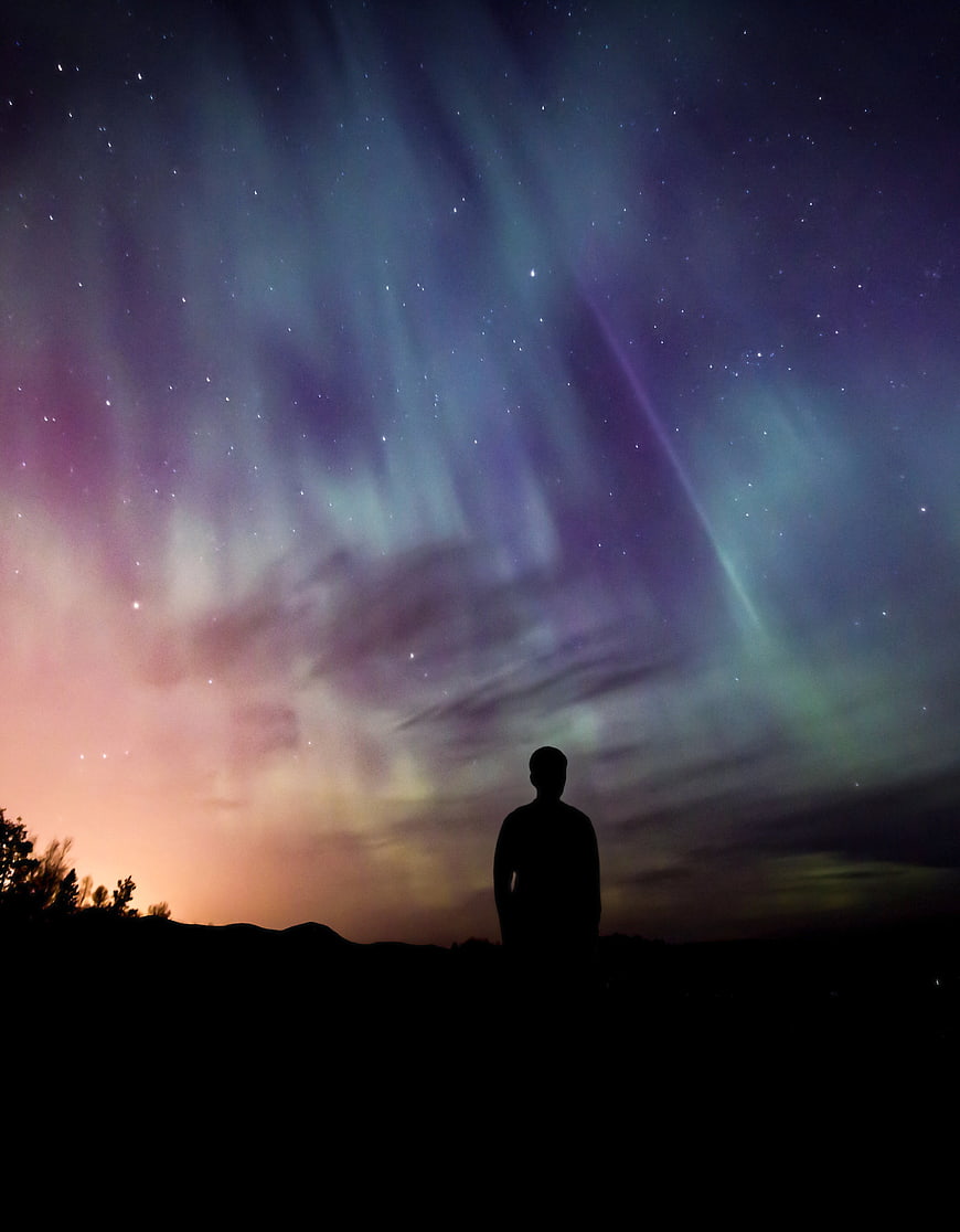 Silhouette of Man Watching Aurora Borealis Night Sky
