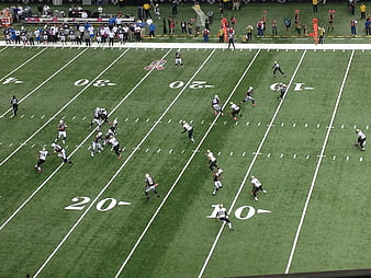 High angle view of American football game on green field