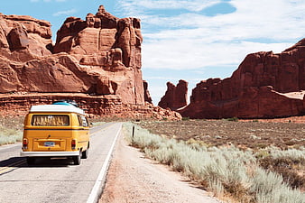Yellow Volkswagen Van Driving on Desert Road